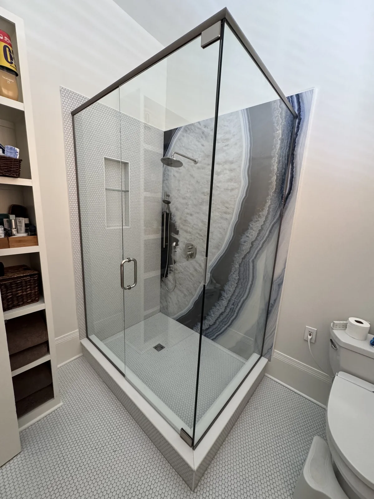 Alternate view of the glass enclosure and patterned shower wall.