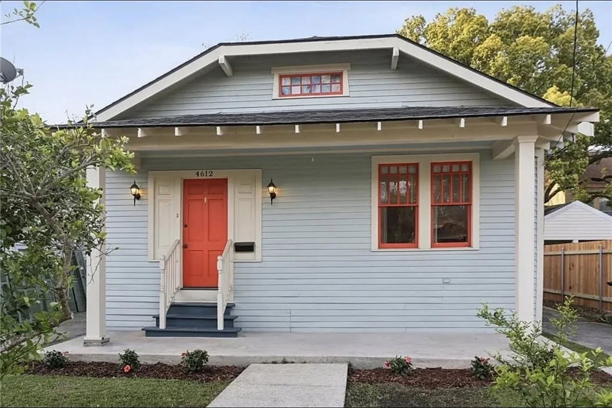 Before: the existing front entry and open concrete porch area.