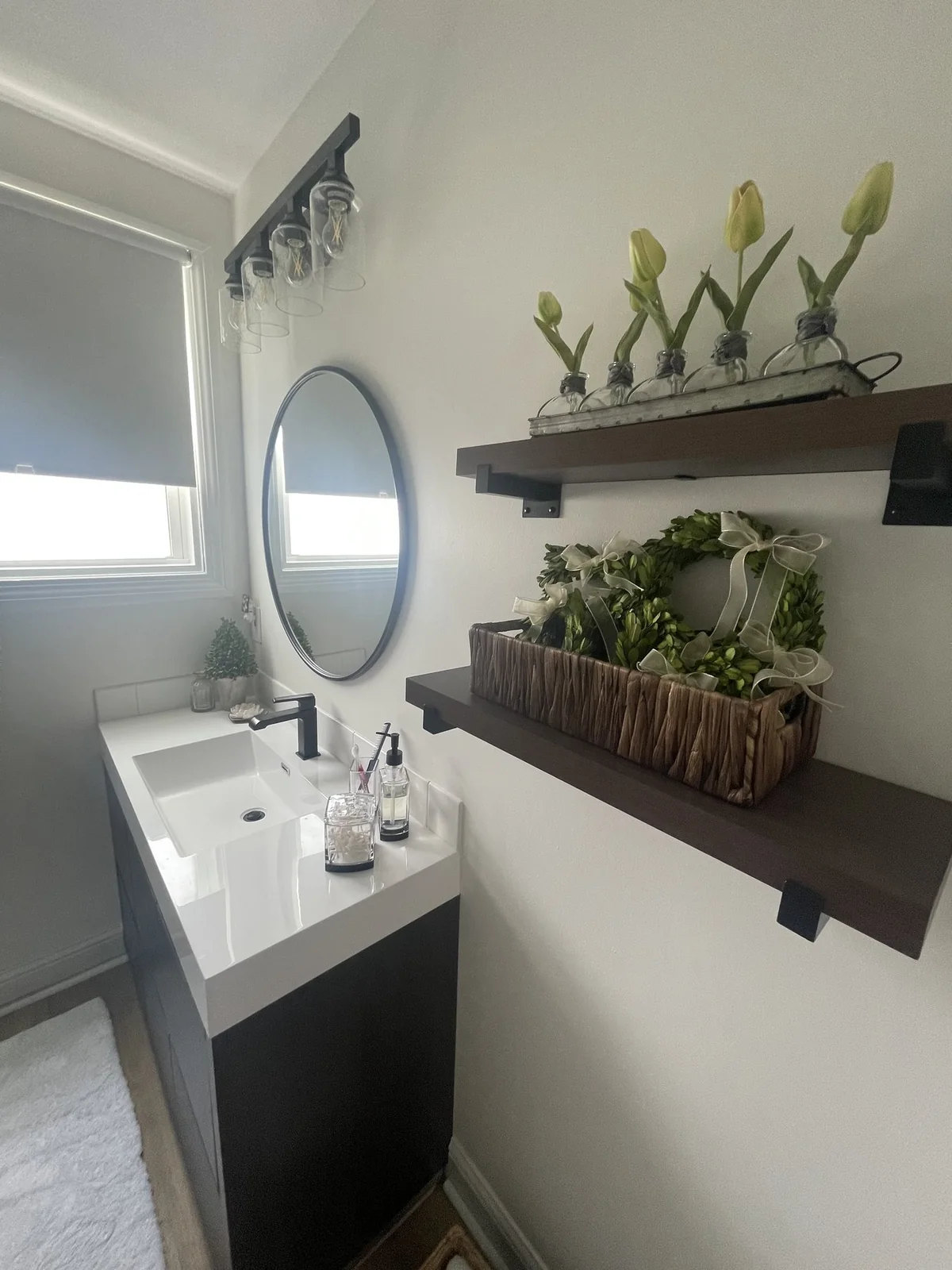 Wider view of the vanity and shelving in the renovated Jefferson bathroom.