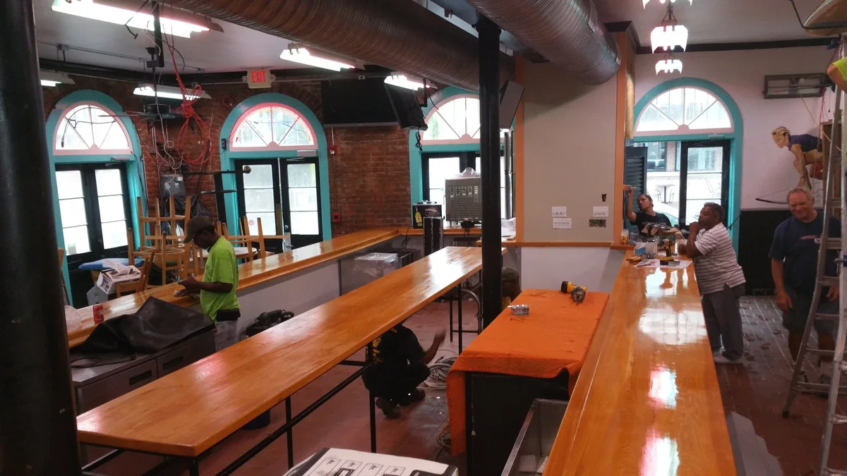The double-sided central bar within the opened restaurant interior.