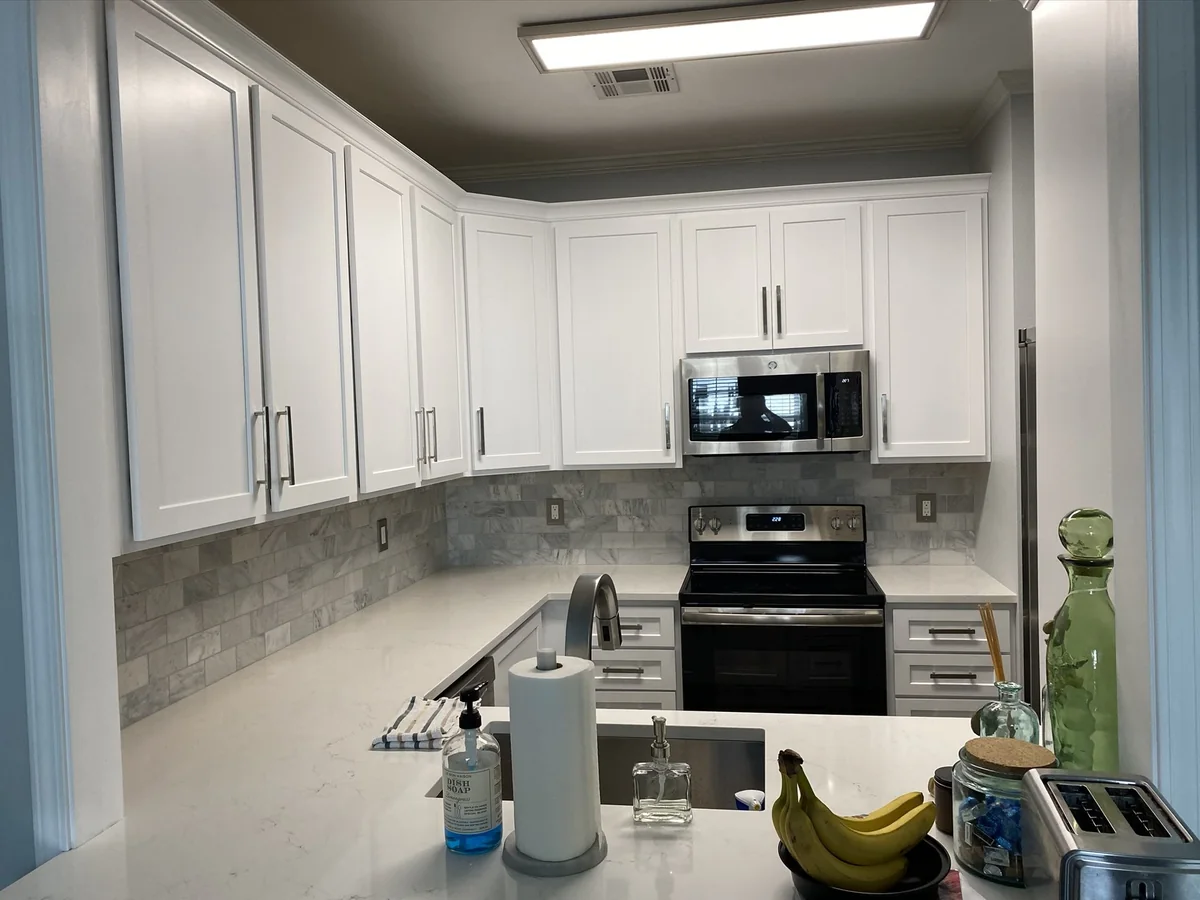 Compact white kitchen with a pass-through sink counter