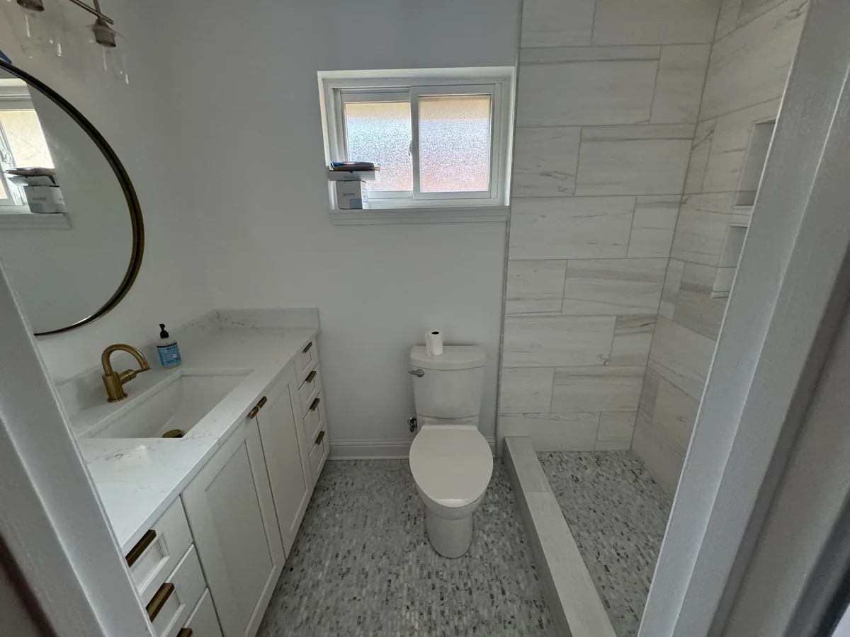 Wide view of vanity and shower