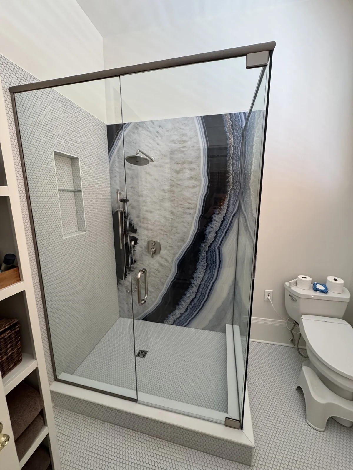 Wider view of the completed glass shower and surrounding bathroom.